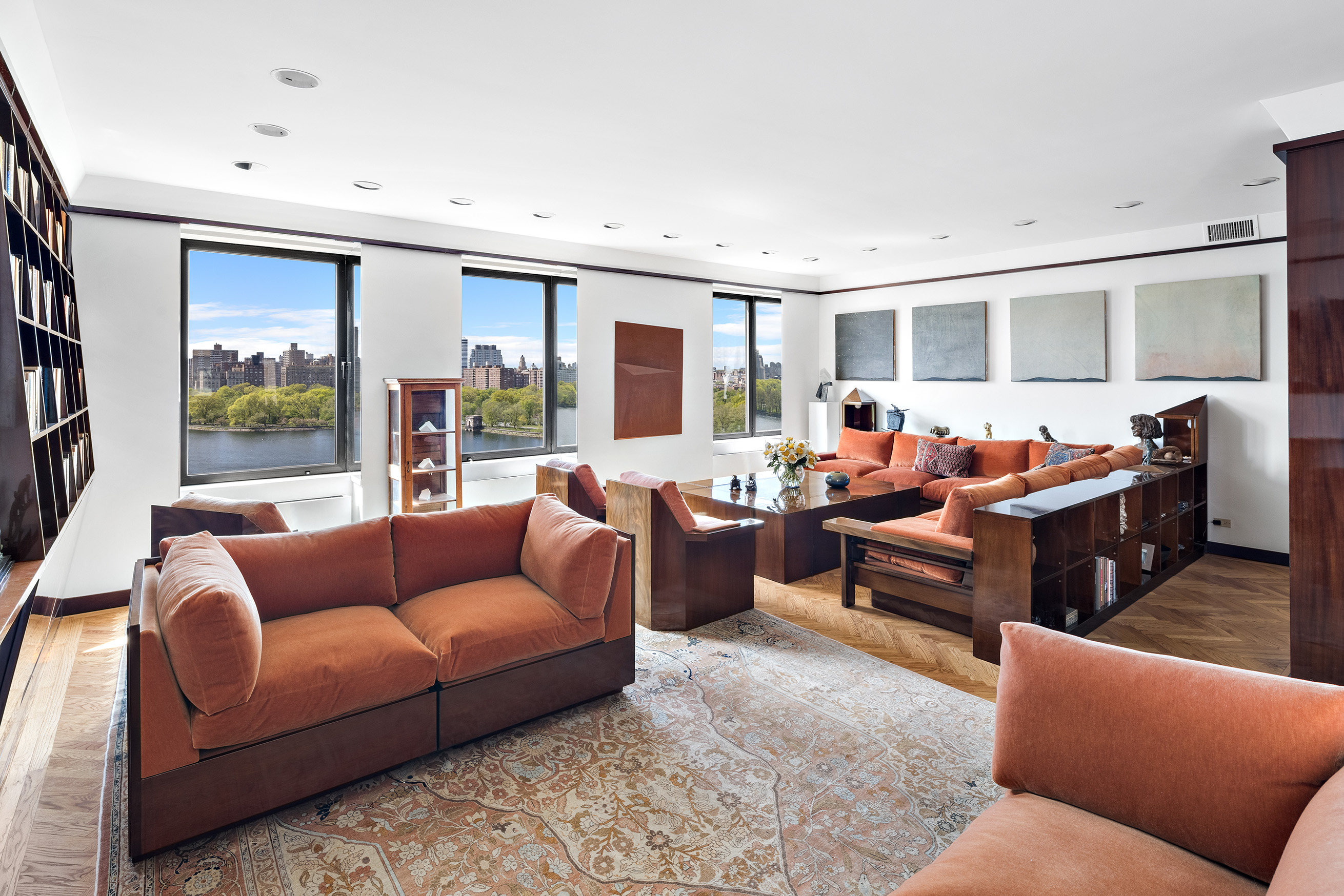 1115 5th Avenue, Unit 15A Manhattan, NY 10128 - Photo 3 of 27 a living room with furniture ceiling fan and a flat screen tv