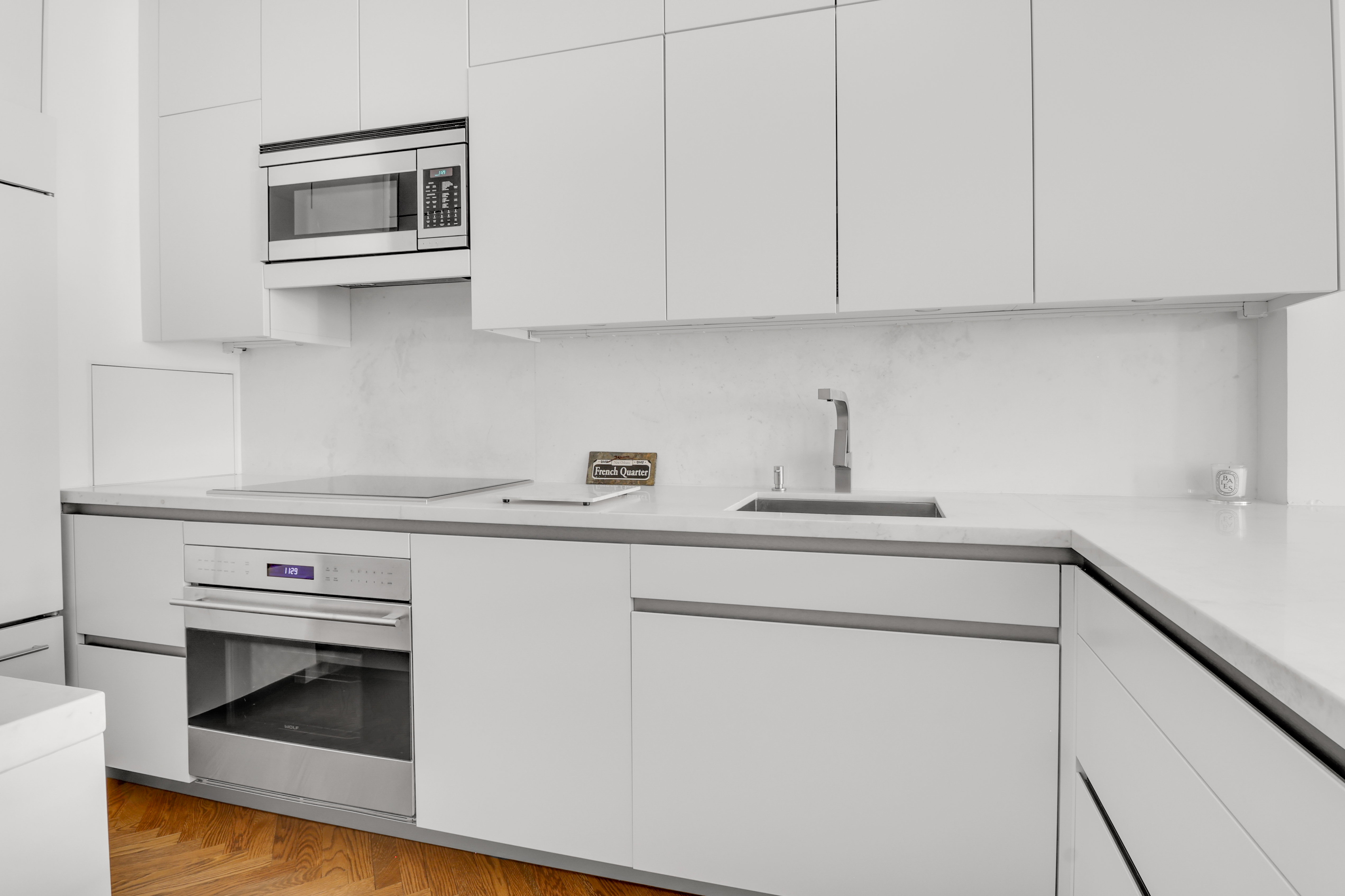 14 East 68th Street, Unit 3 Manhattan, NY 10065 - Photo 6 of 16 a kitchen with stainless steel appliances a stove and white cabinets