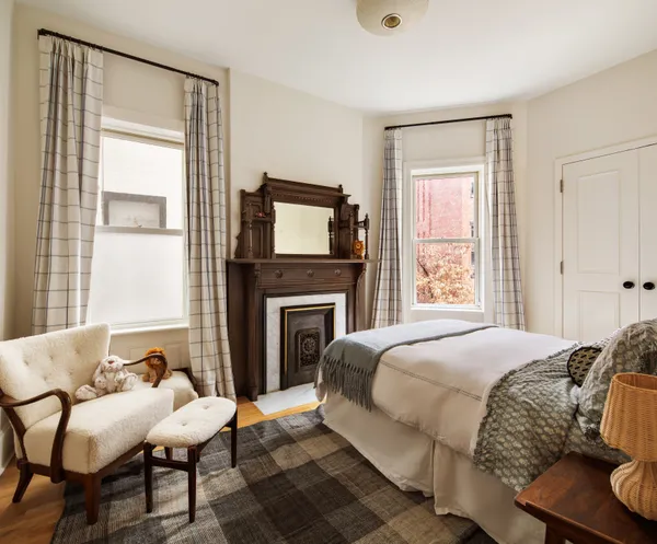 a bedroom with a bed and a fireplace