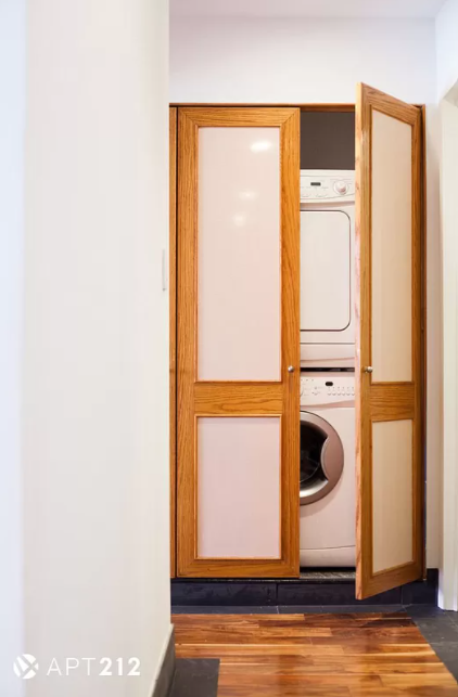 179 Grand Street, Unit 2F Manhattan, NY 10013 - Photo 6 of 13 a view of a storage & utility room with washer and dryer