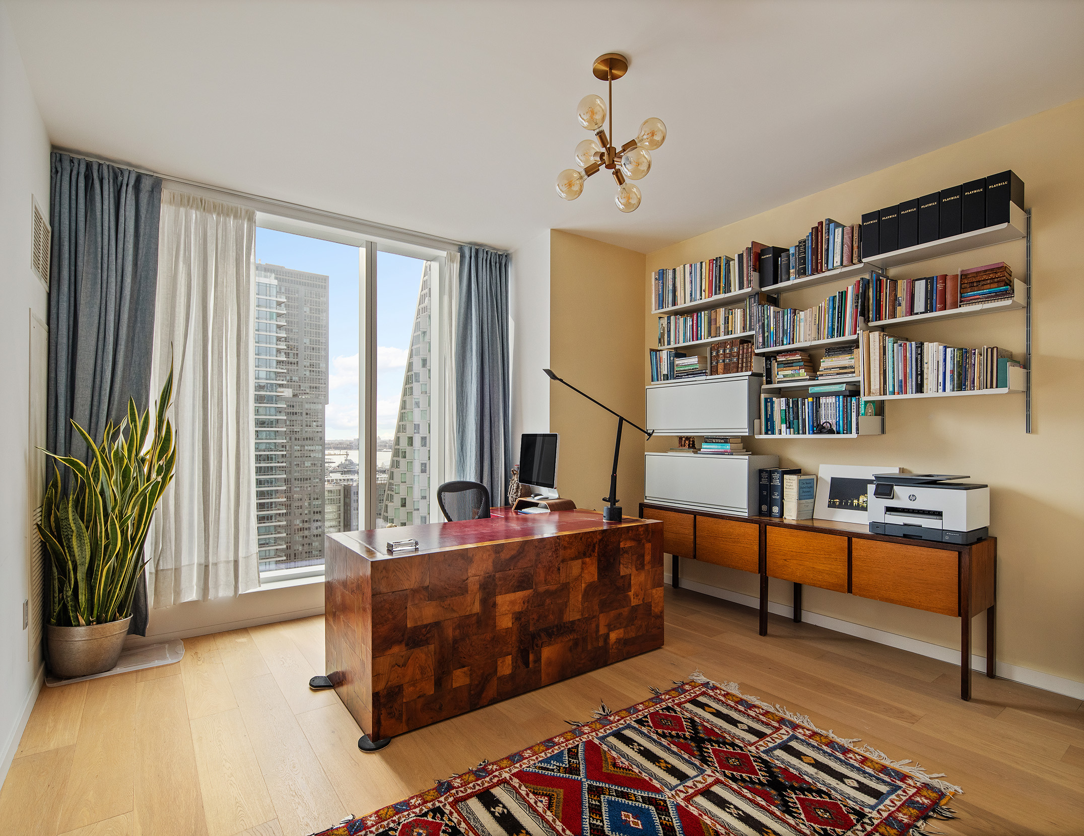 1 West End Avenue, Unit 22E Manhattan, NY 10023 - Photo 8 of 32 a bedroom with furniture and a book shelf
