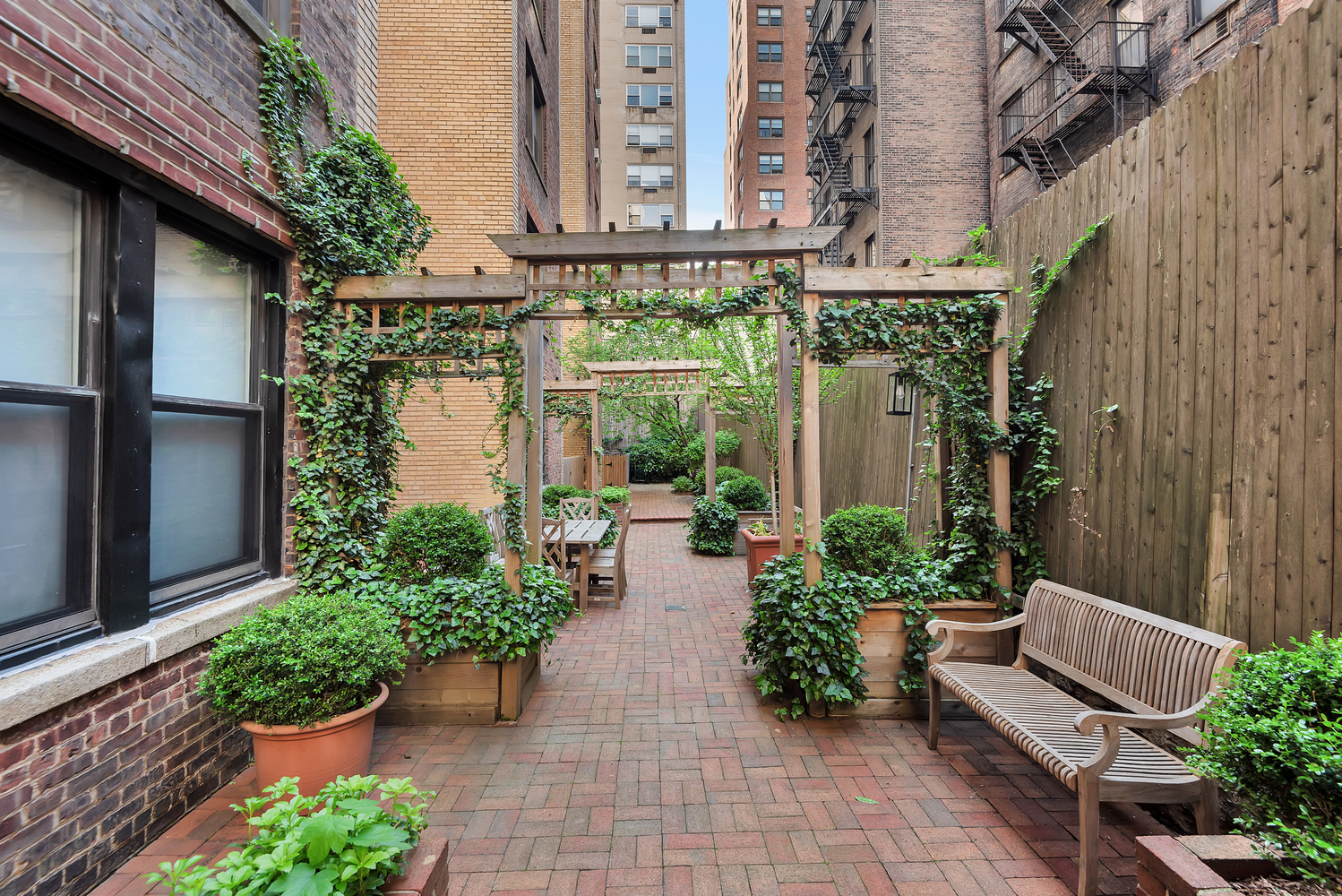 151 East 83rd Street, Unit 2E Manhattan, NY 10028 - Photo 11 of 12 a view of a house with chairs and plants