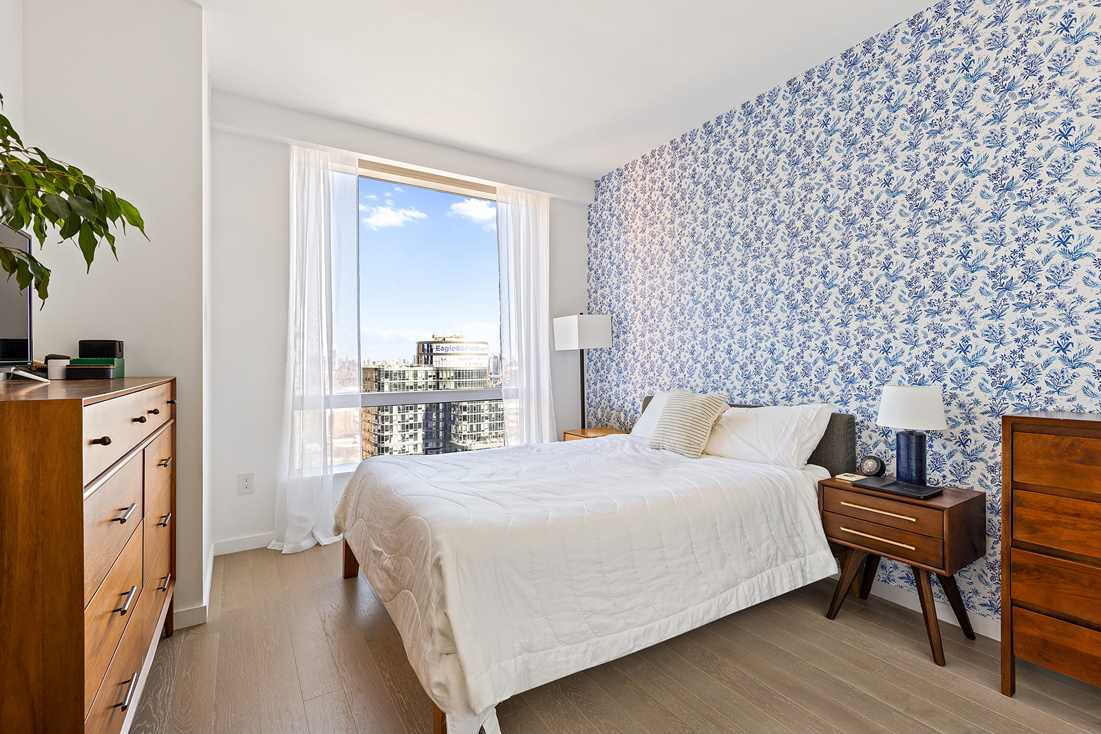 1 City Point, Unit 36D Brooklyn, NY 11201 - Photo 2 of 16 a bedroom with a bed and a potted plant next to a window