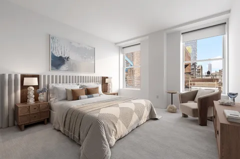 a bedroom with a bed couch and a window