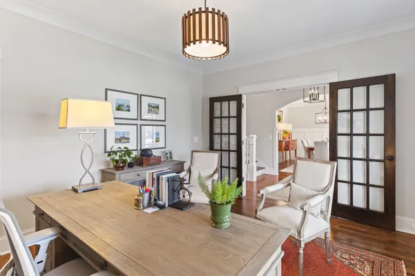 a dining room with furniture and wooden floor