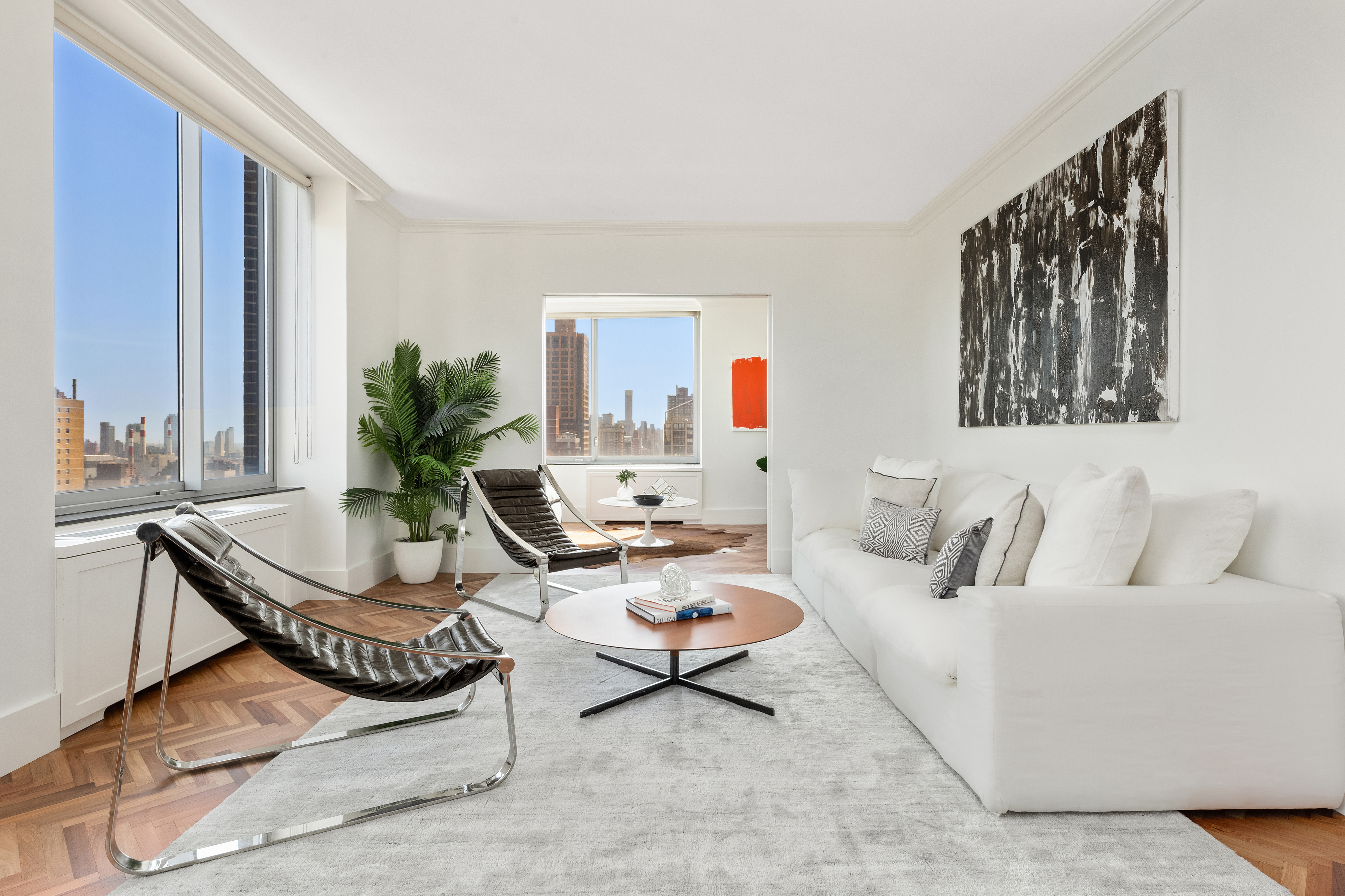 360 East 88th Street, Unit 31C Manhattan, NY 10128 - Photo 4 of 24 a living room with furniture and a large window