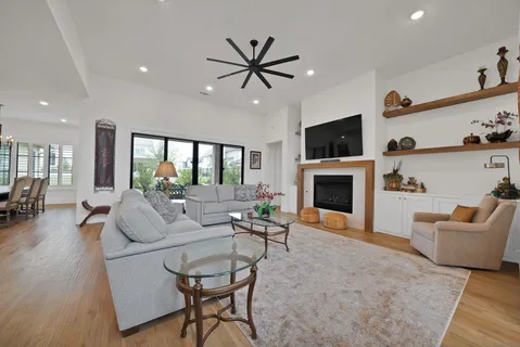 a living room with furniture a flat screen tv and a fireplace