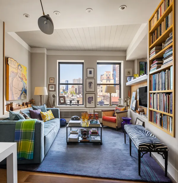 a living room with furniture and a book shelf