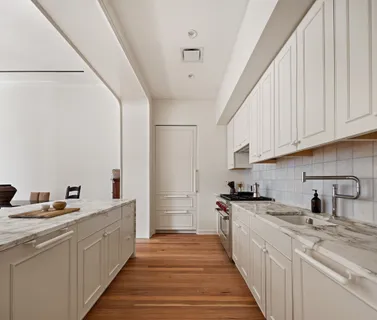 a kitchen with stainless steel appliances a sink stove and cabinets