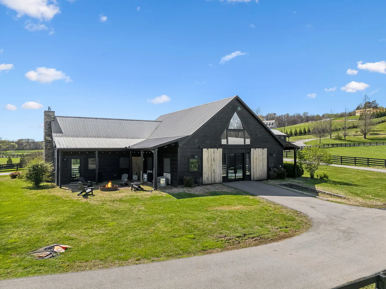 a view of a house with a patio and a yard