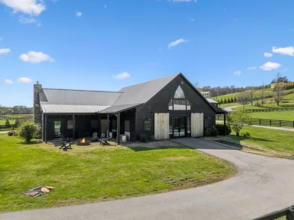 a view of a house with a patio and a yard