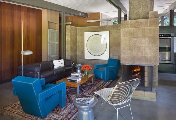 a living room with furniture a rug and a window