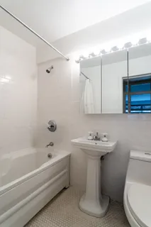 a bathroom with a sink a toilet and bathtub