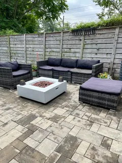 a backyard of a house with seating space and outdoor seating