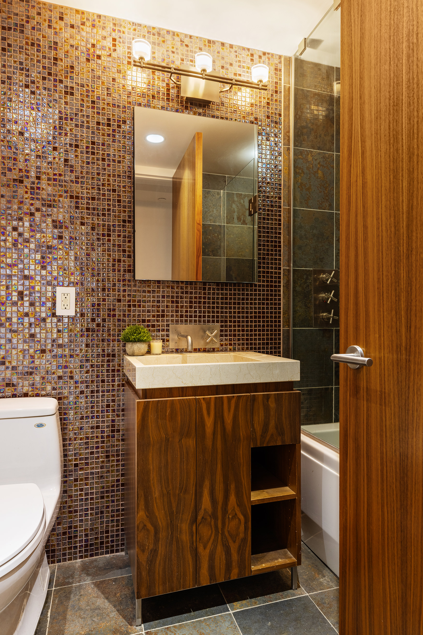 271 West 122nd Street, Unit A Manhattan, NY 10027 - Photo 7 of 19 a bathroom with a sink a toilet and shower