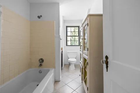 a bathroom with a bathtub sink and toilet