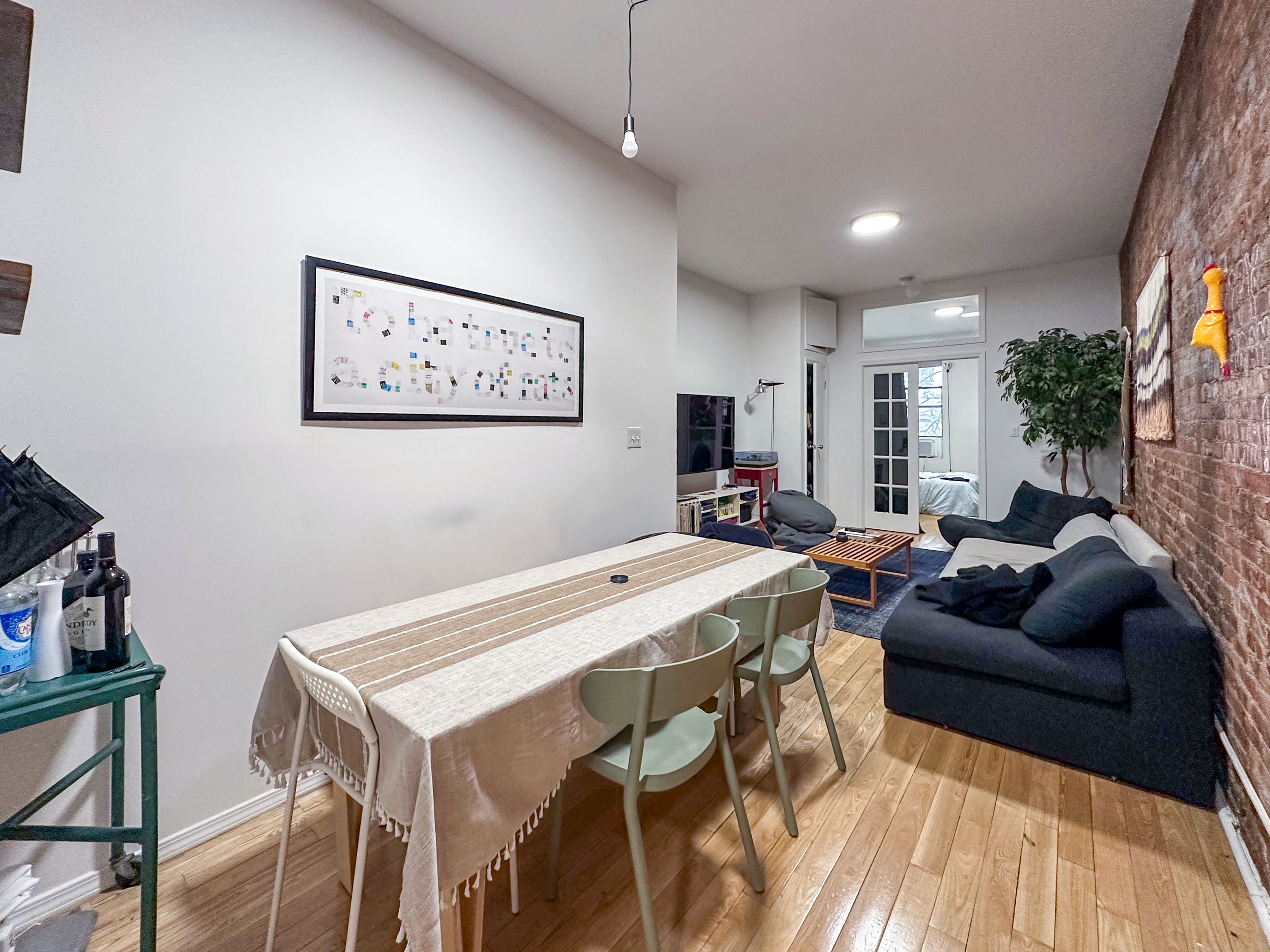 213 East 5th Street, Unit 5 Manhattan, NY 10003 - Photo 6 of 17 a living room with furniture a flat screen tv and a table