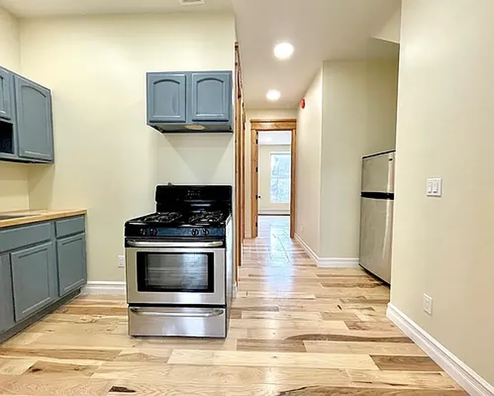 1120 Greene Avenue, Unit 1 Brooklyn, NY 11221 - Photo 2 of 13 a kitchen with stainless steel appliances granite countertop a stove a refrigerator and a microwave