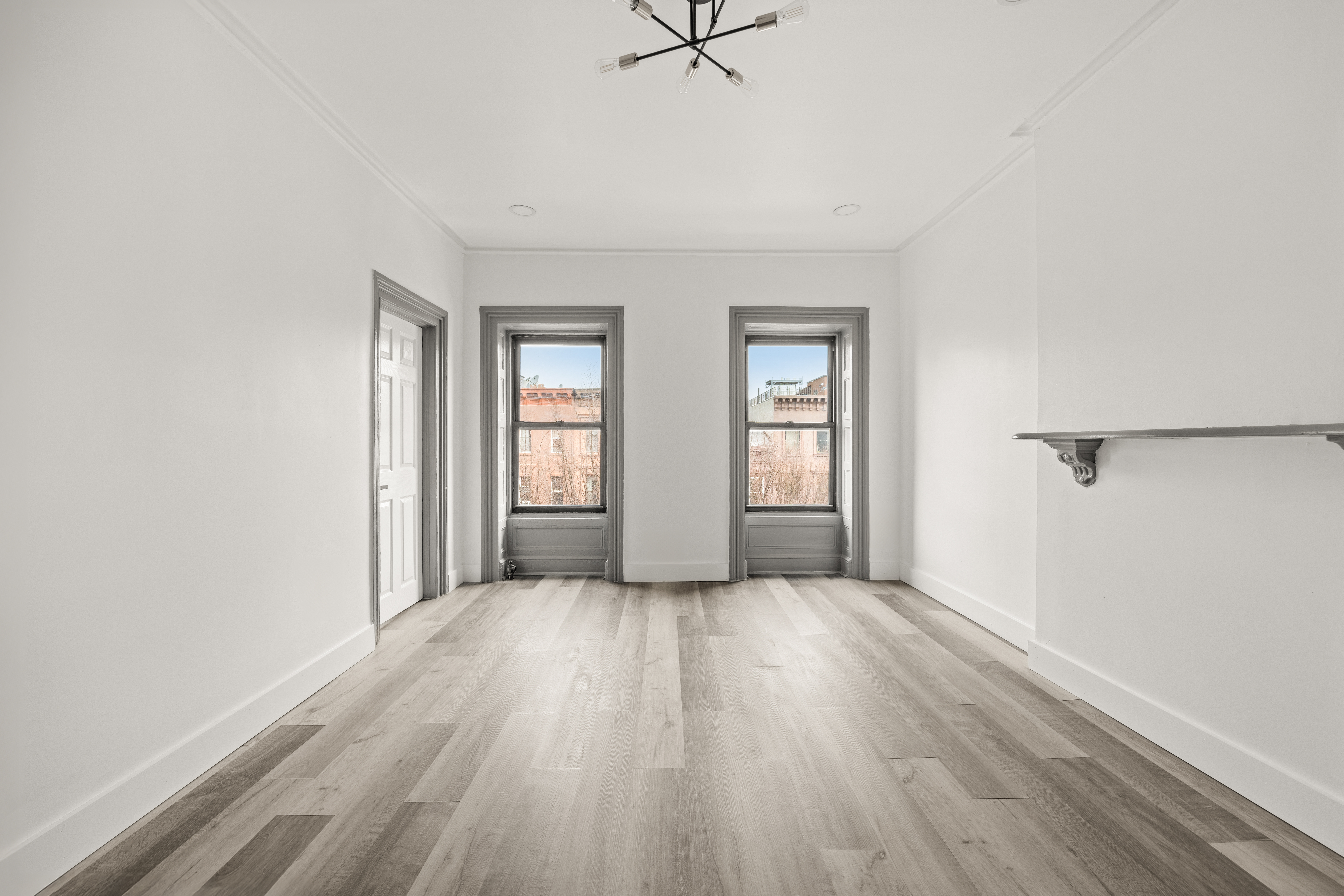 126 Quincy Street, Unit 3 Brooklyn, NY 11216 - Photo 2 of 11 an empty room with wooden floor and windows