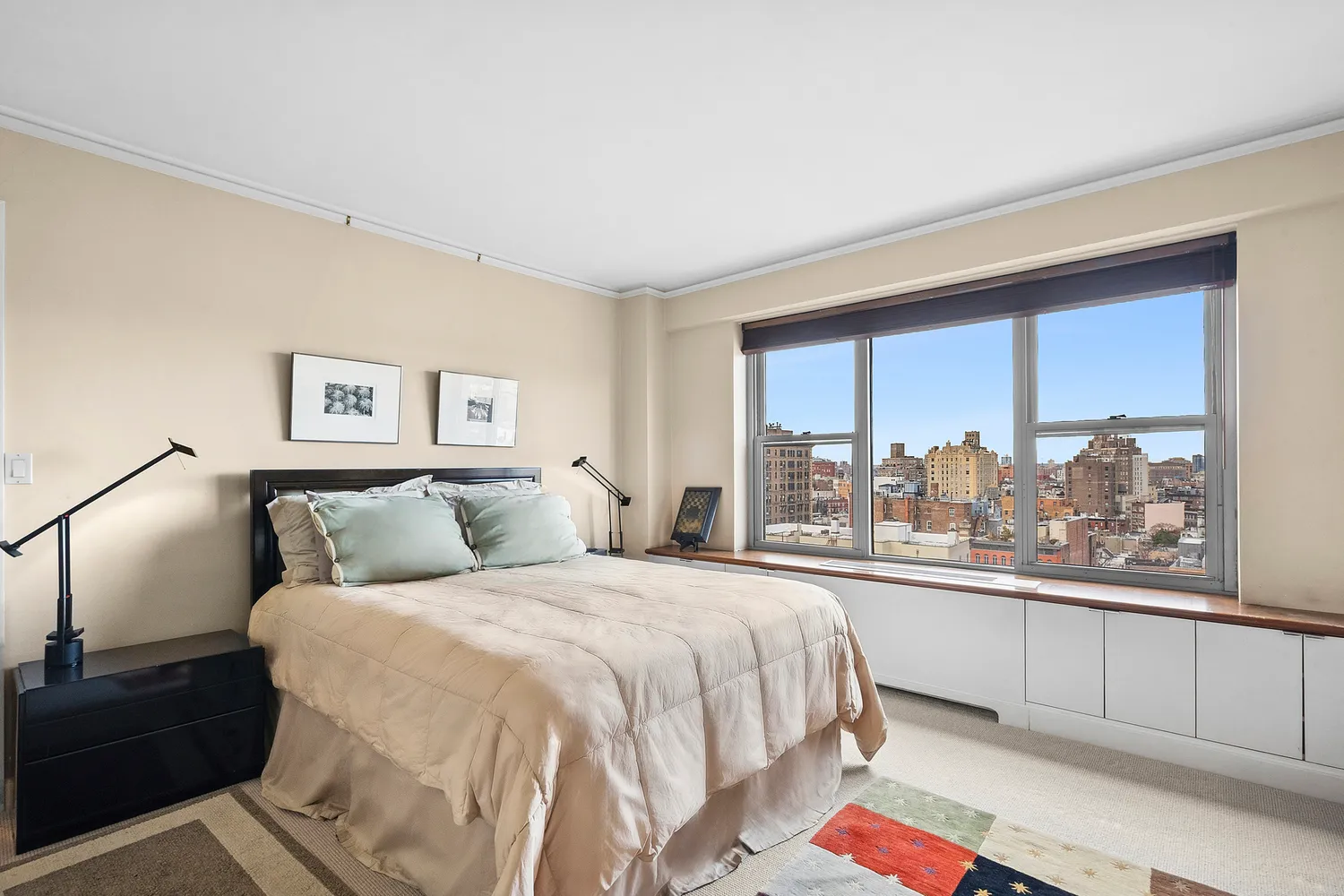 a bedroom with a bed and a large window