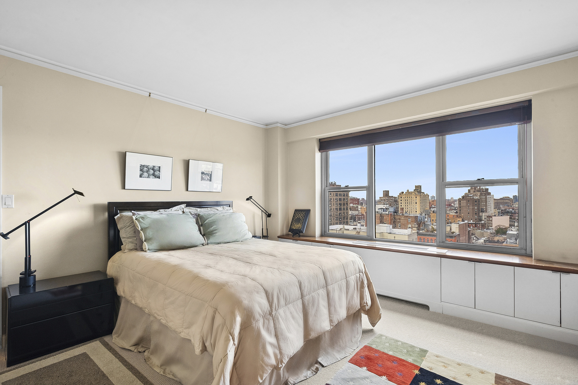 2 5th Avenue, Unit 15U Manhattan, NY 10011 - Photo 4 of 13 a bedroom with a bed and a large window