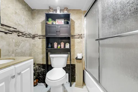 a white toilet sitting next to a bathroom sink