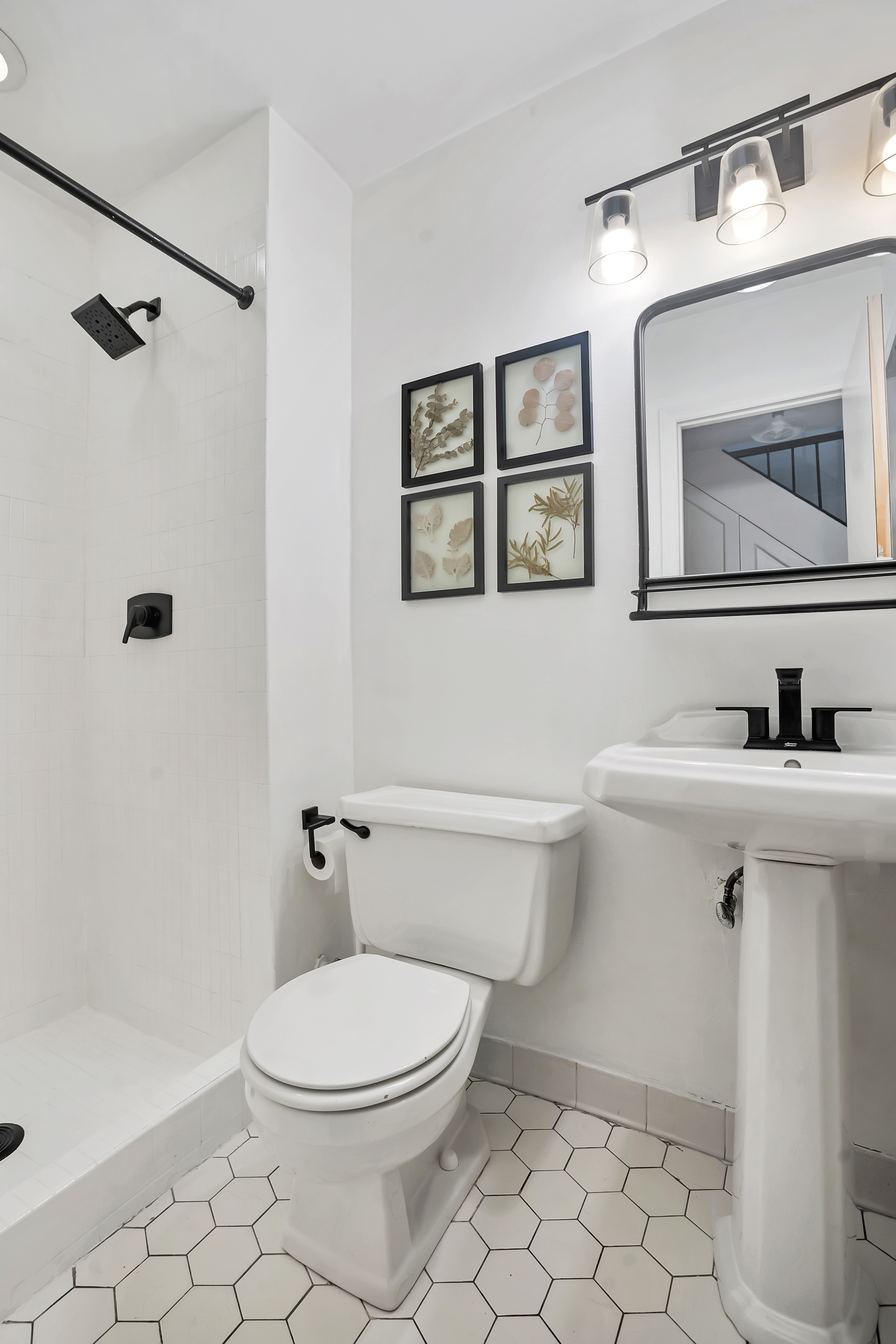255 West 95th Street, Unit 6D Manhattan, NY 10025 - Photo 8 of 16 a bathroom with a toilet a sink a mirror and a shower