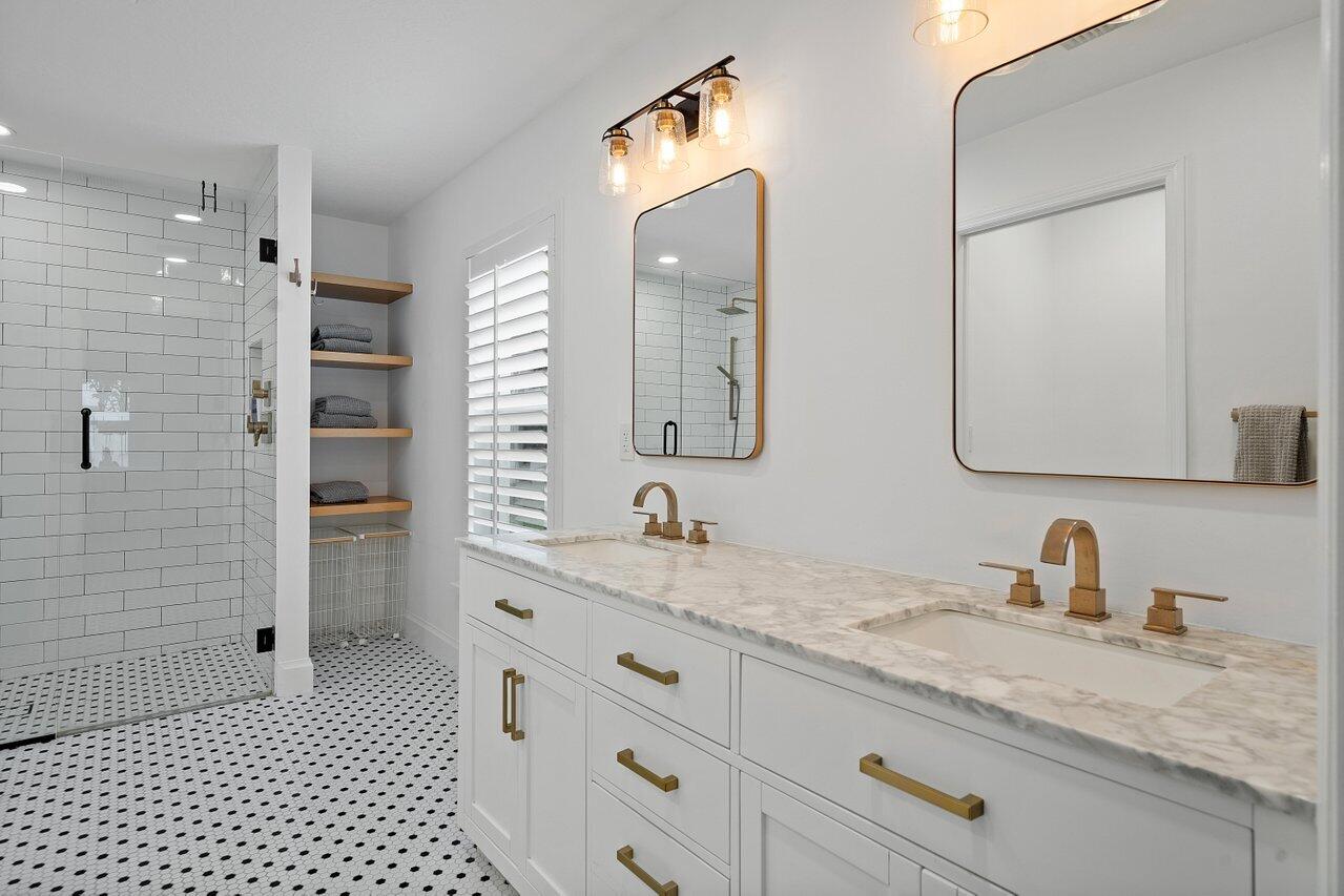 1182 Canoe Point Delray Beach, FL 33444 - Photo 17 of 46 a bathroom with a granite countertop double vanity sink and mirror