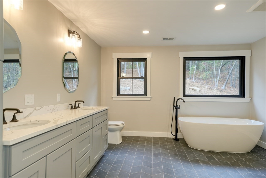171 Randall Road Berlin, MA 01503 - Photo 24 of 41 a bathroom with a toilet sink and mirror