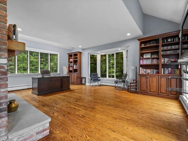 a living room with furniture and a book shelf