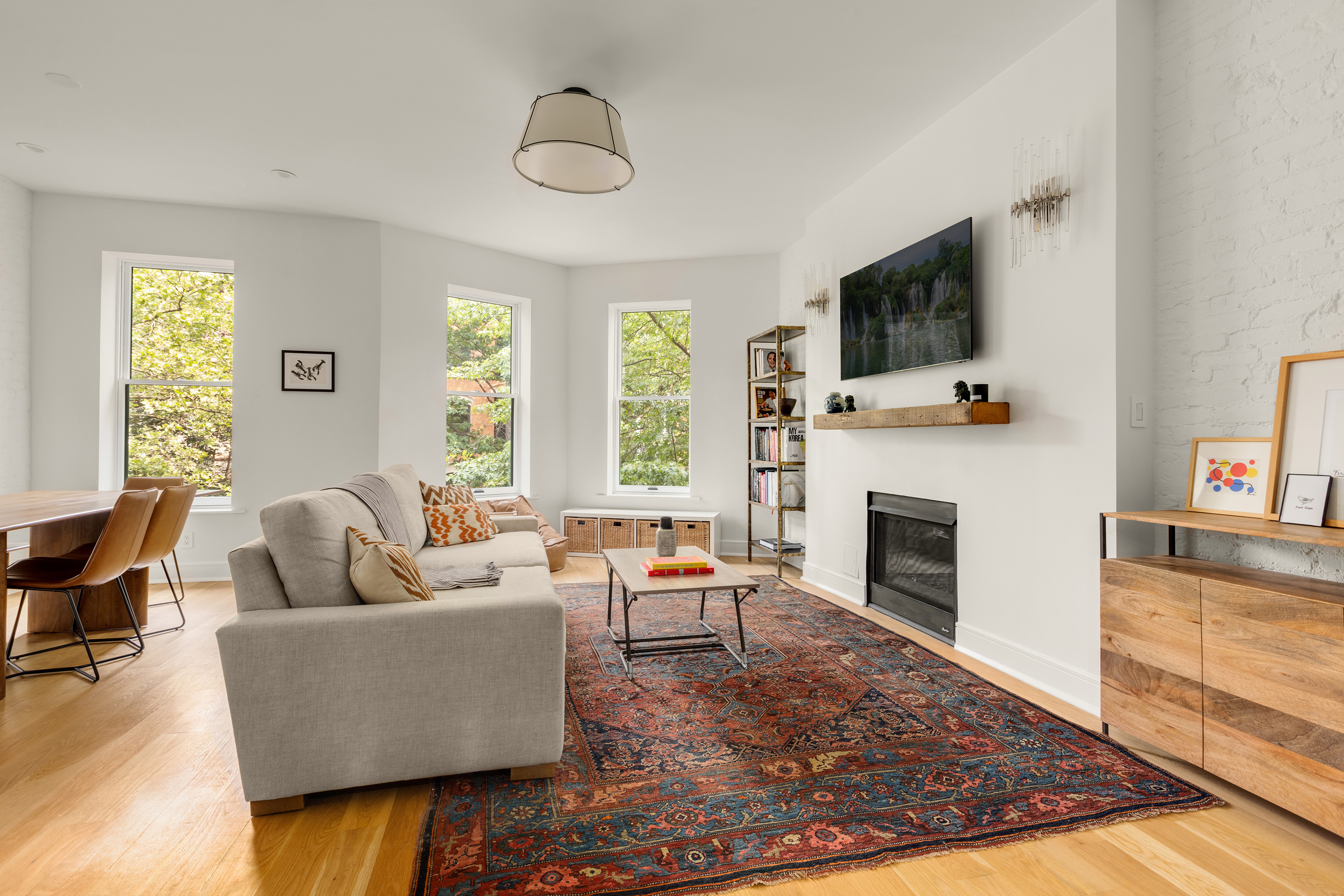 352 6th Avenue, Unit 3 Brooklyn, NY 11215 - Photo 1 of 14 a living room with furniture a flat screen tv and a fireplace