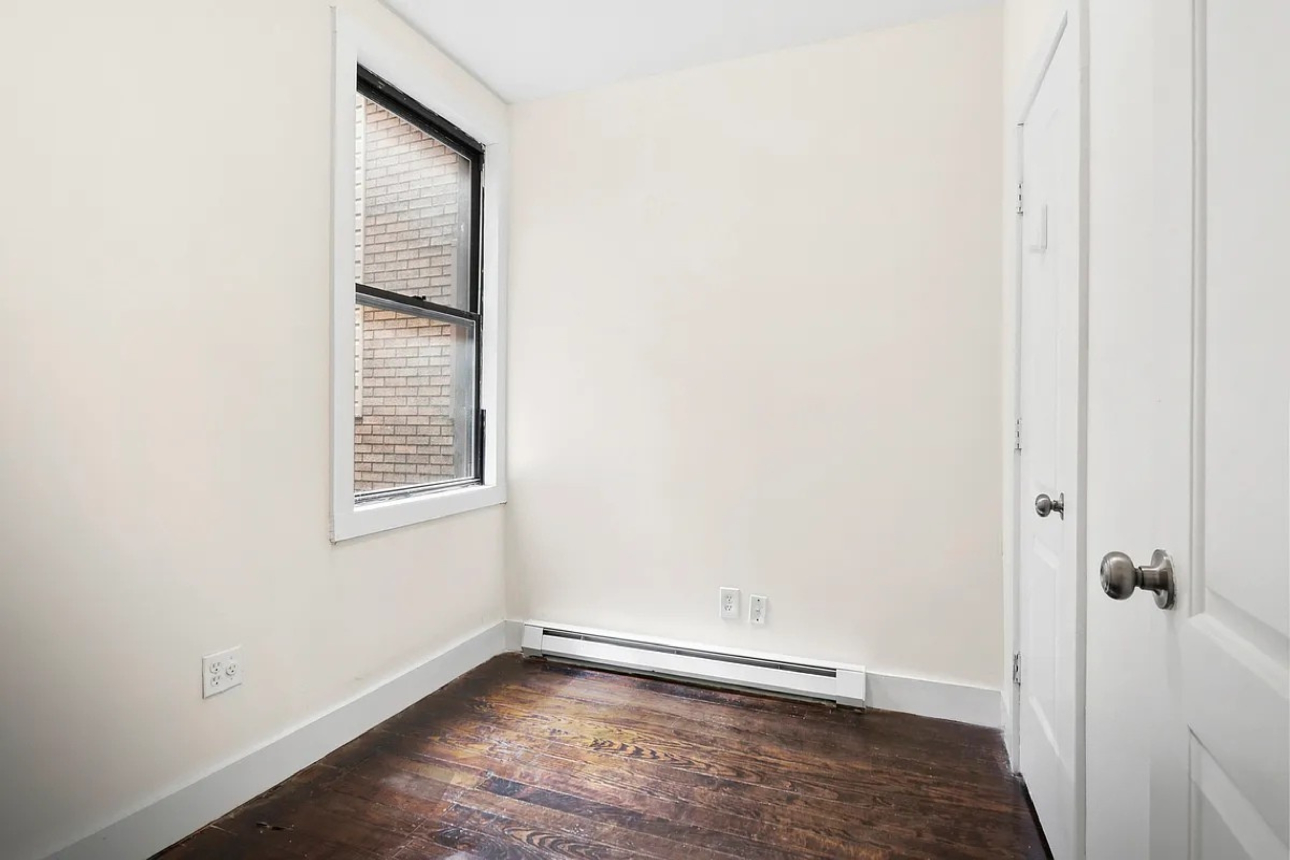 22-42 41st Street, Unit 2R Queens, NY 11105 - Photo 7 of 10 a view of an empty room with wooden floor and a window