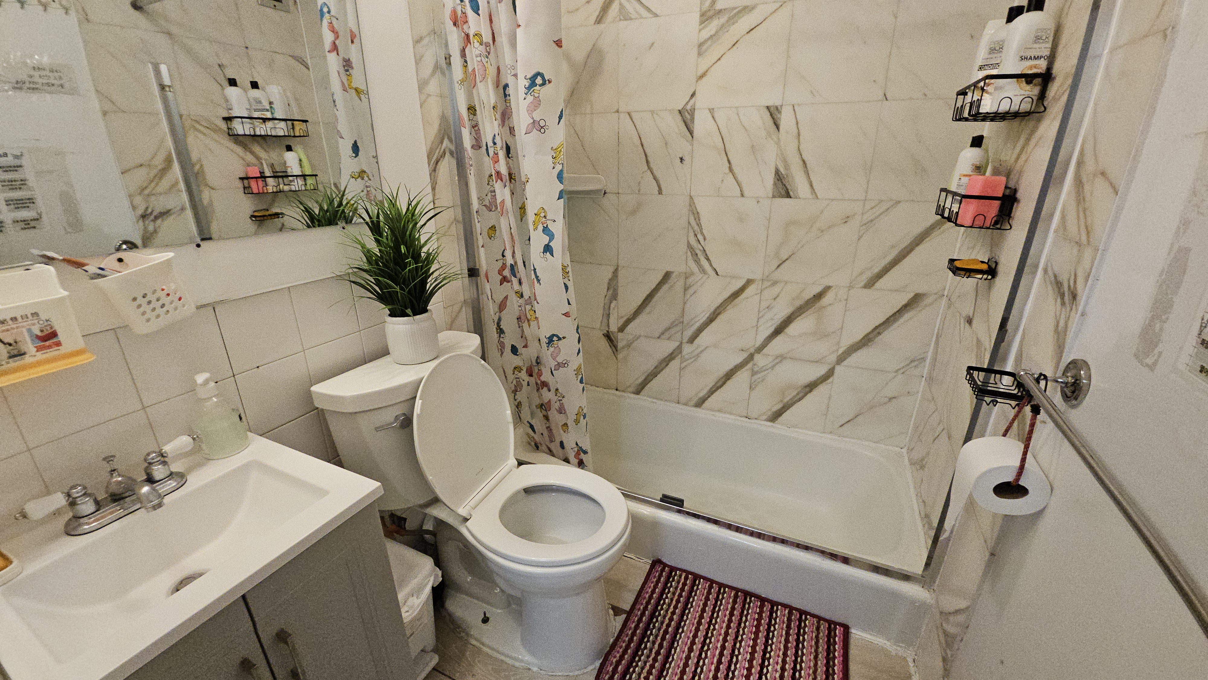 408 8th Avenue, Unit 5C Manhattan, NY 10001 - Photo 12 of 17 a bathroom with a sink toilet and shower
