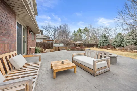 a view of a patio with couches and a fire pit