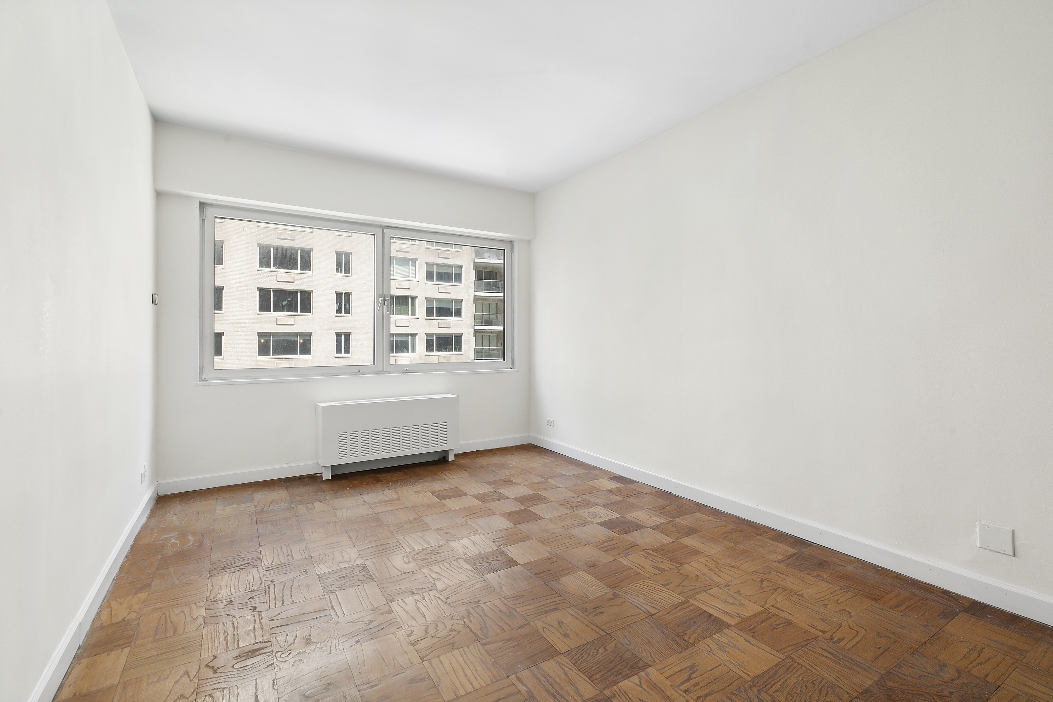 58 West 58th Street, Unit 4C Manhattan, NY 10019 - Photo 11 of 14 an empty room with windows