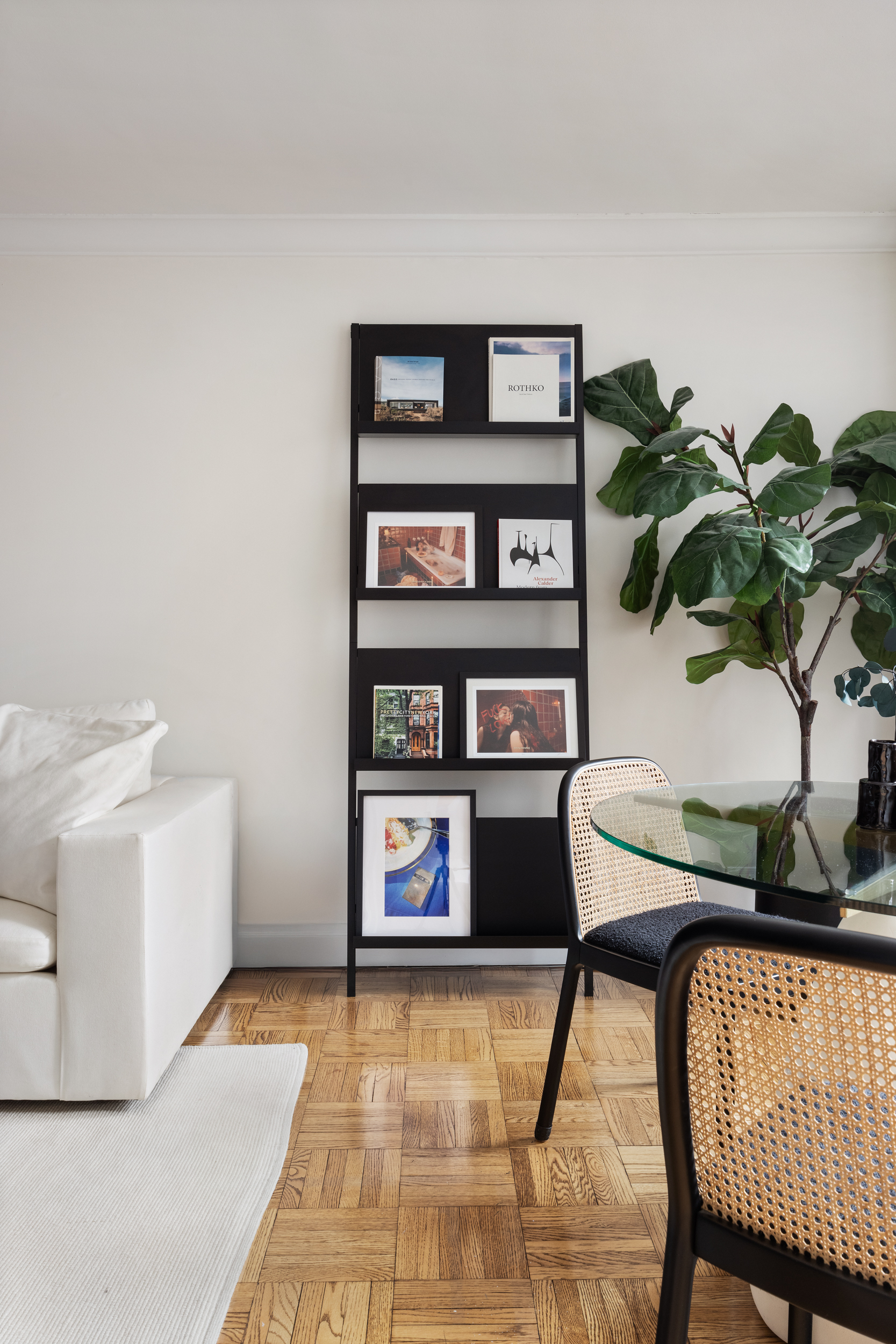 175 West 12th Street, Unit 4L Manhattan, NY 10011 - Photo 4 of 11 a living room with furniture and a book shelf