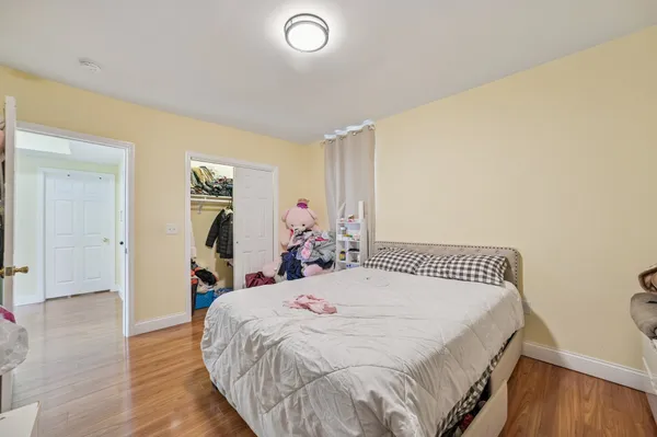 a bed sitting in a bedroom and table