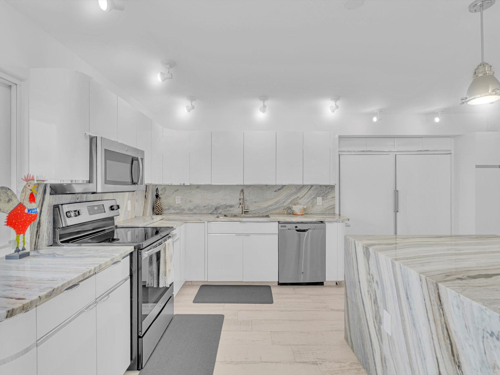3000 South Ocean Boulevard, Unit 1504 Boca Raton, FL 33432 - Photo 12 of 64 a kitchen with a sink stove and cabinets