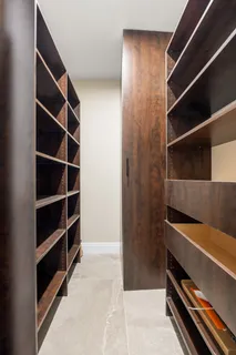 a view of walk in closet with empty racks