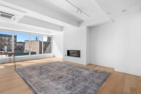 a view of an empty room with a fireplace