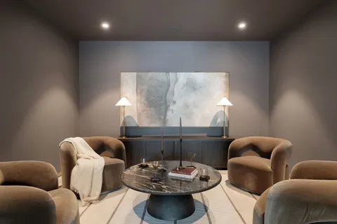 a living room with furniture and a chandelier