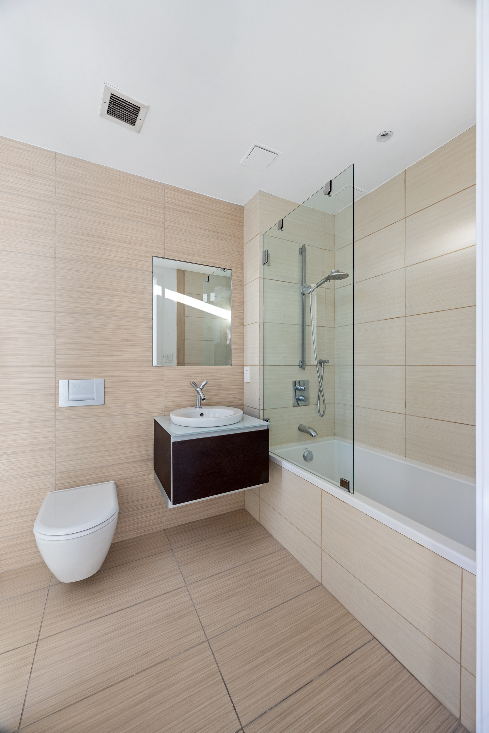 166 West 18th Street, Unit 7D Manhattan, NY 10011 - Photo 5 of 10 a bathroom with a toilet a sink and bathtub