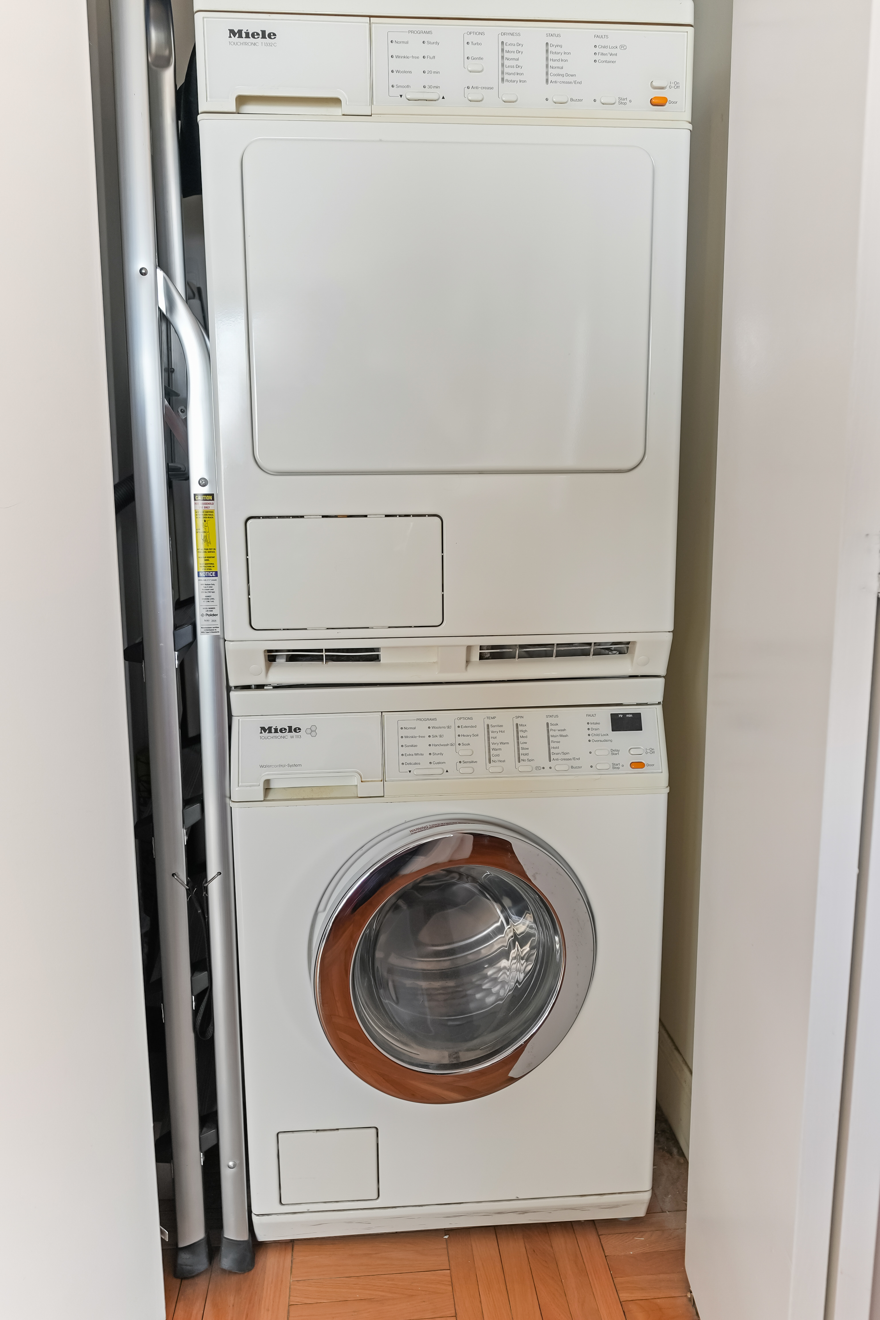 215-217 East 96th Street, Unit 32F Manhattan, NY 10128 - Photo 6 of 8 a close up view of a washer and dryer