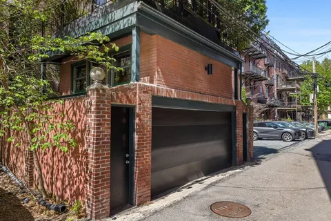 a front view of a house with parking area