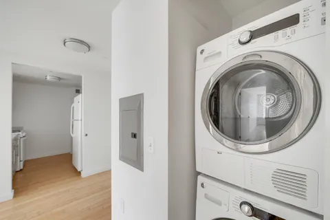 a view of a chair and table in back yard of the building