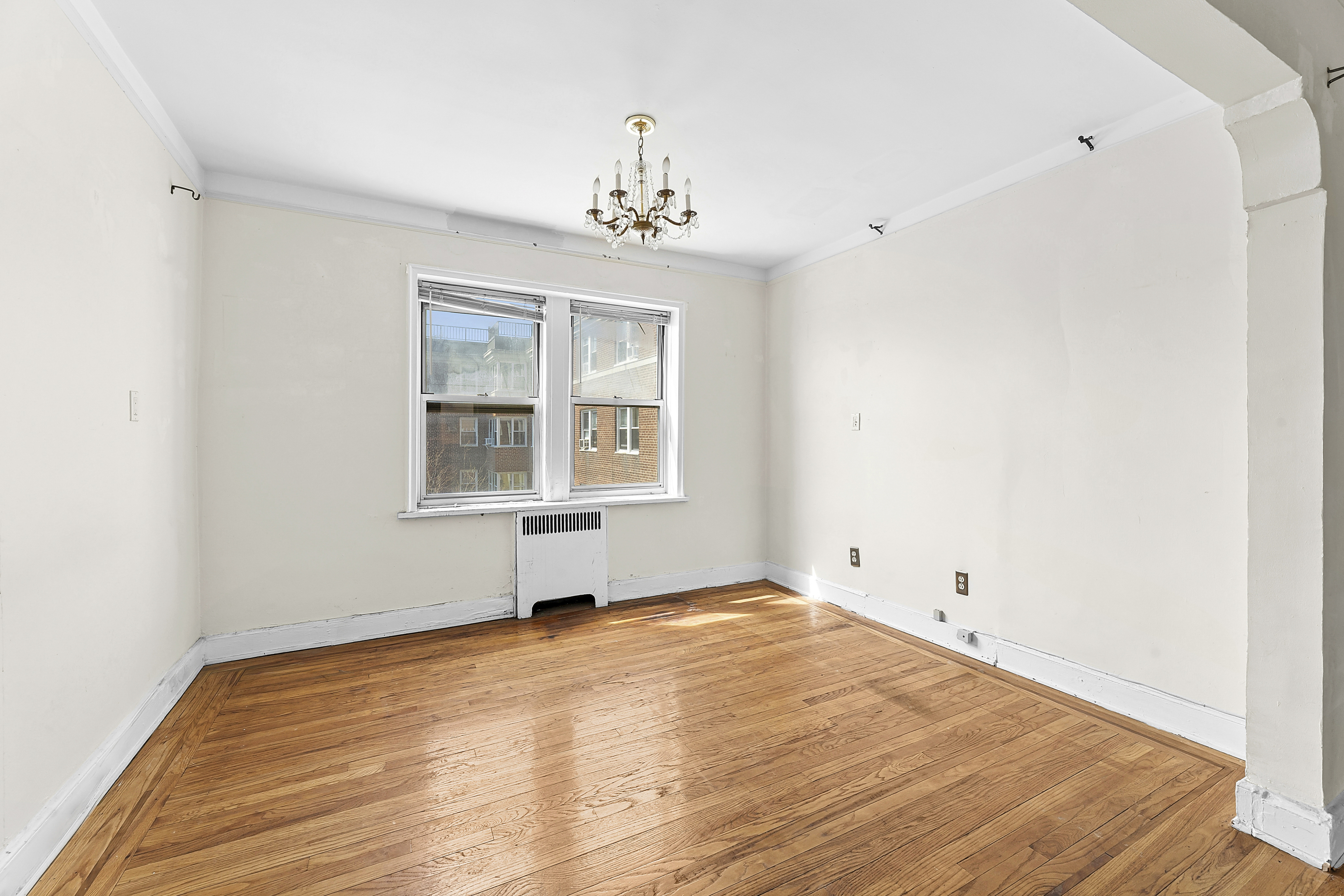 5444 Arlington Avenue, Unit G51 Bronx, NY 10471 - Photo 5 of 16 a view of empty room with wooden floor and fan