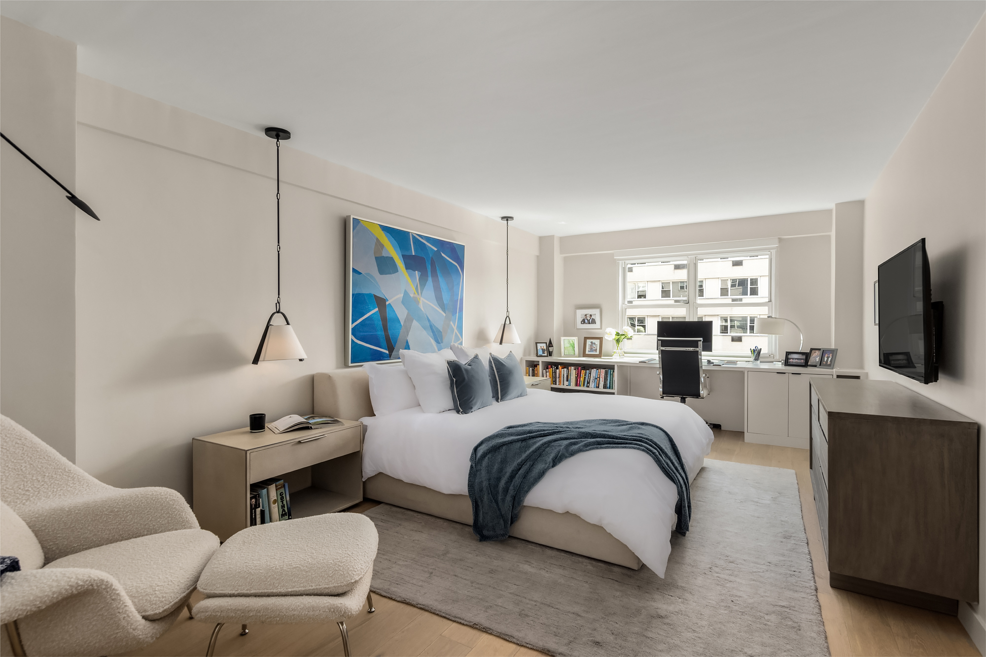 101 West 12th Street, Unit 12R Manhattan, NY 10011 - Photo 11 of 21 a bed room with furniture and a flat screen tv