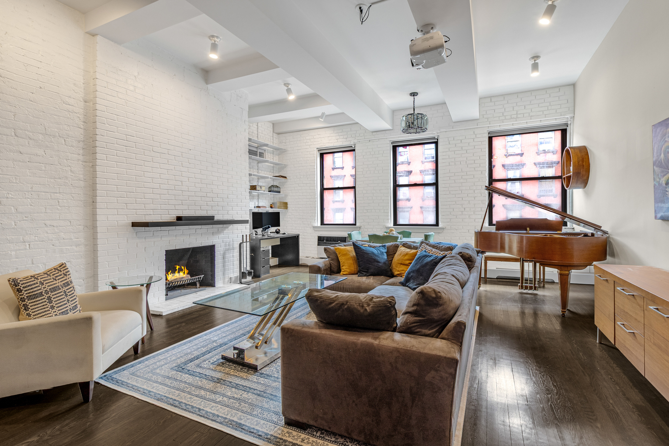a living room with furniture a fireplace and a table