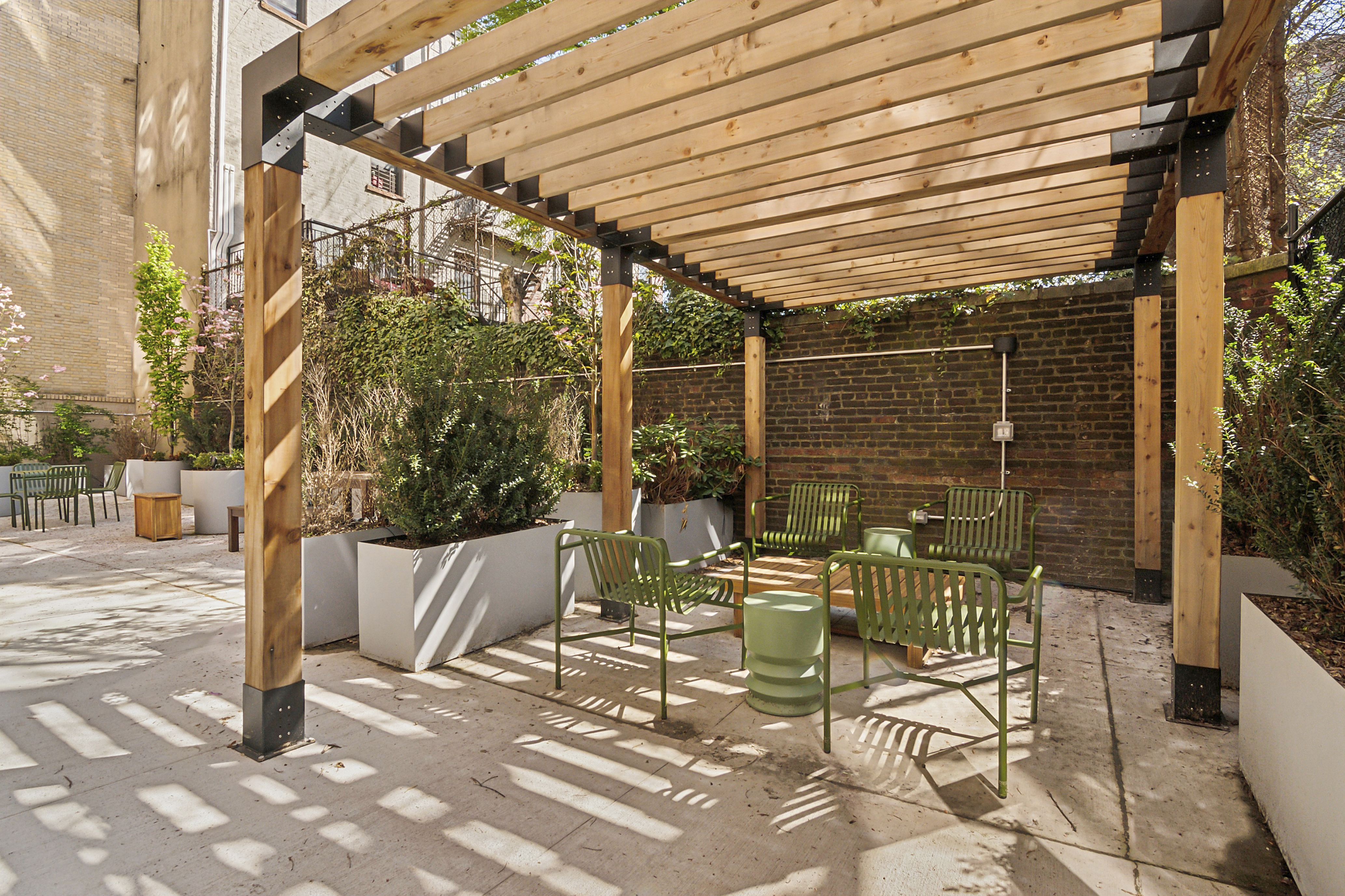 180 Bainbridge Street, Unit 111 Brooklyn, NY 11233 - Photo 5 of 25 a patio with table and chairs and potted plants