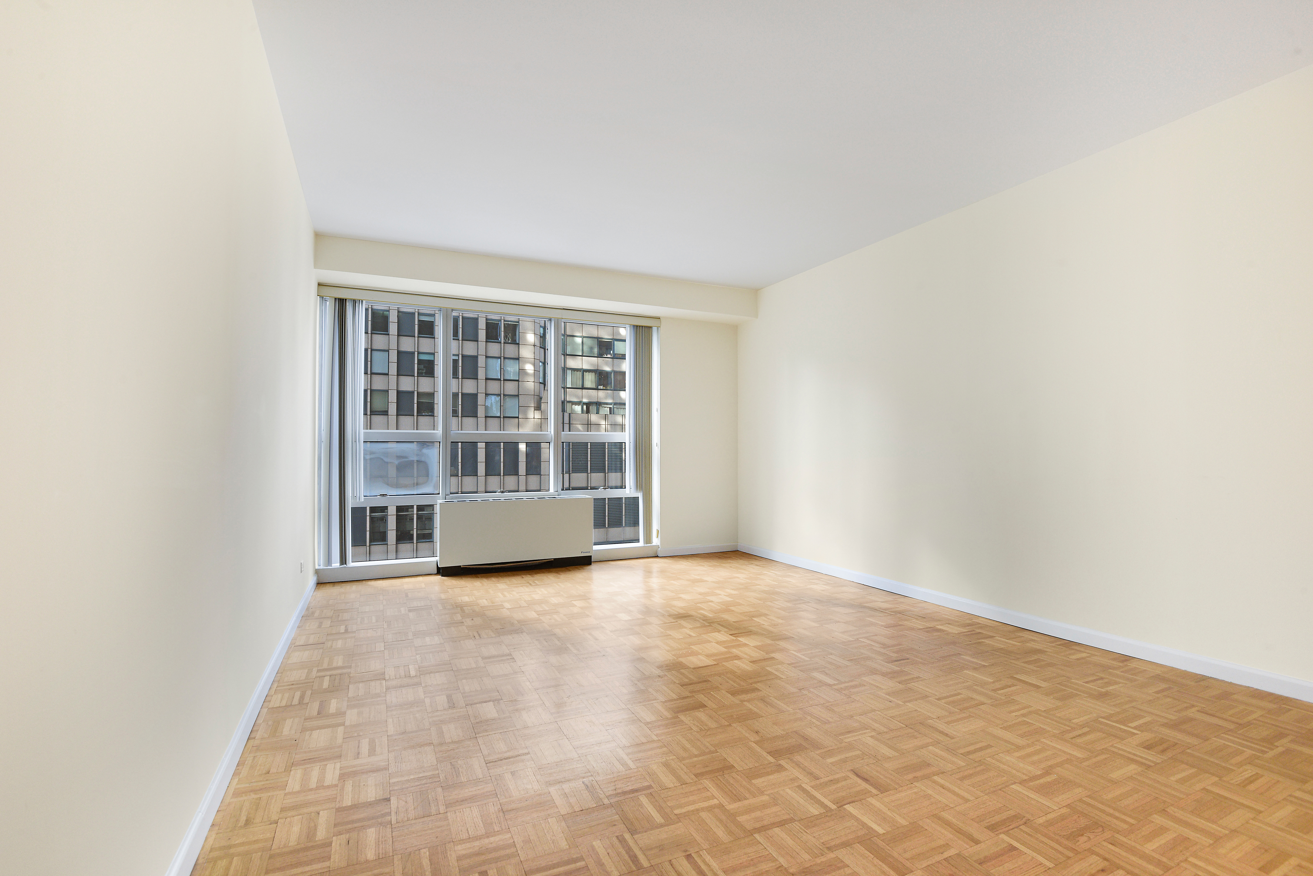 146 West 57th Street, Unit 38E Manhattan, NY 10019 - Photo 10 of 16 a view of an empty room with a window